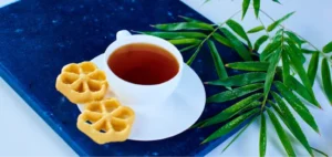 food-photography-of-a-cup-of-tea-served-with-snacks-on-a-textured-blue-surface