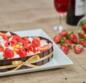 heart-shaped-chocolate-cake-with-strawberries-and-a-bottle-of-red-wine