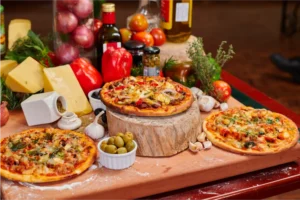 three-vegetable-pizzas-displayed-on-a-wooden-board-with-fresh-ingredients